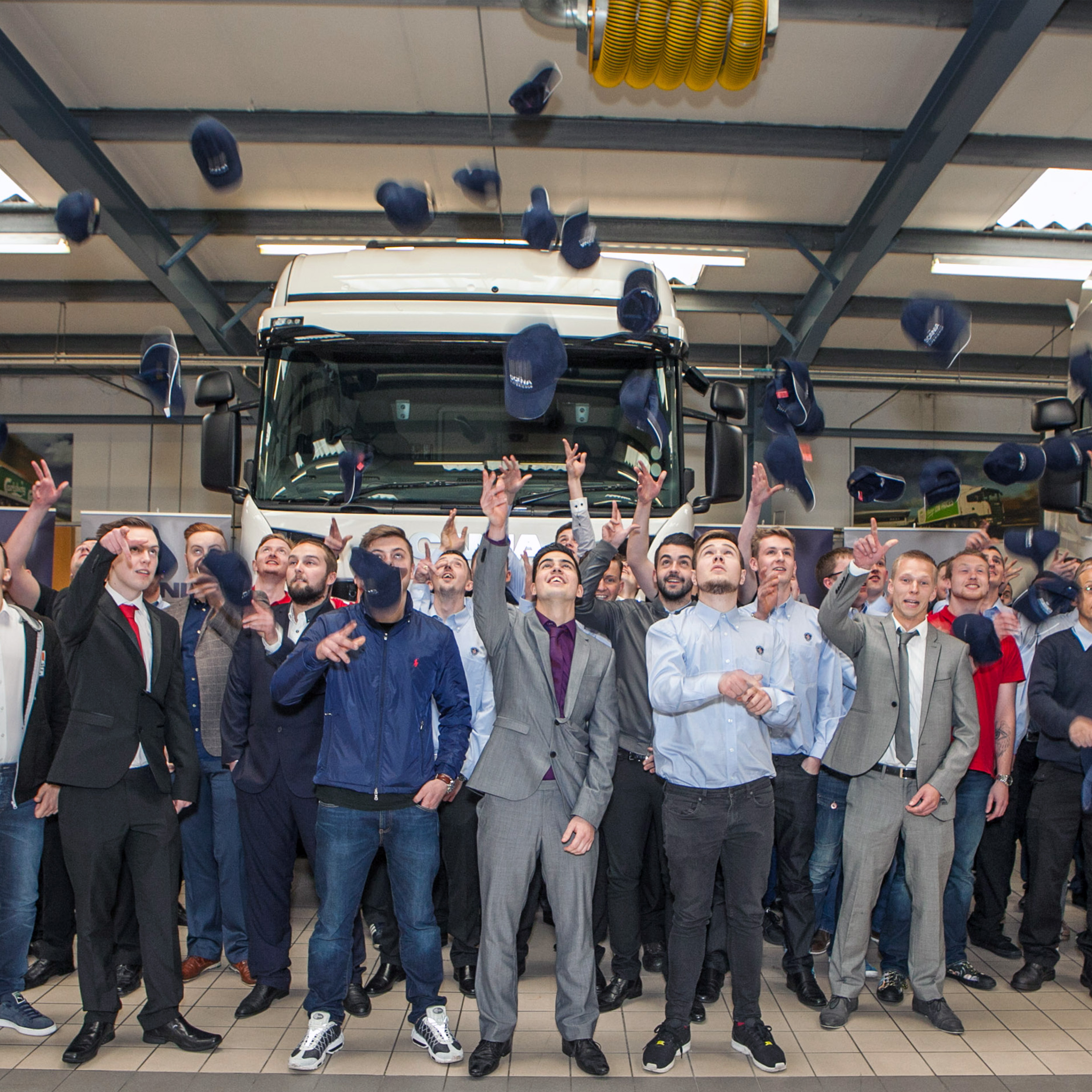 Apprentices throwing caps in the air